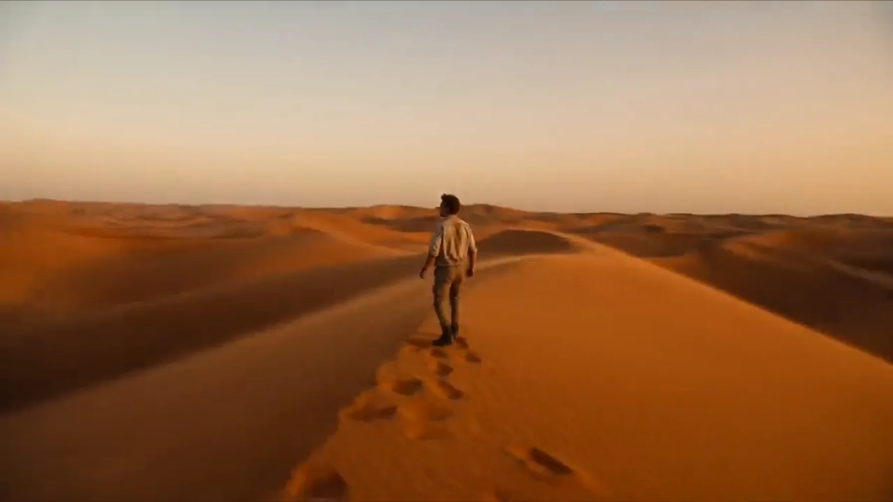 Sora video extender using a lone explorer crossing a vast landscape as the visual reference